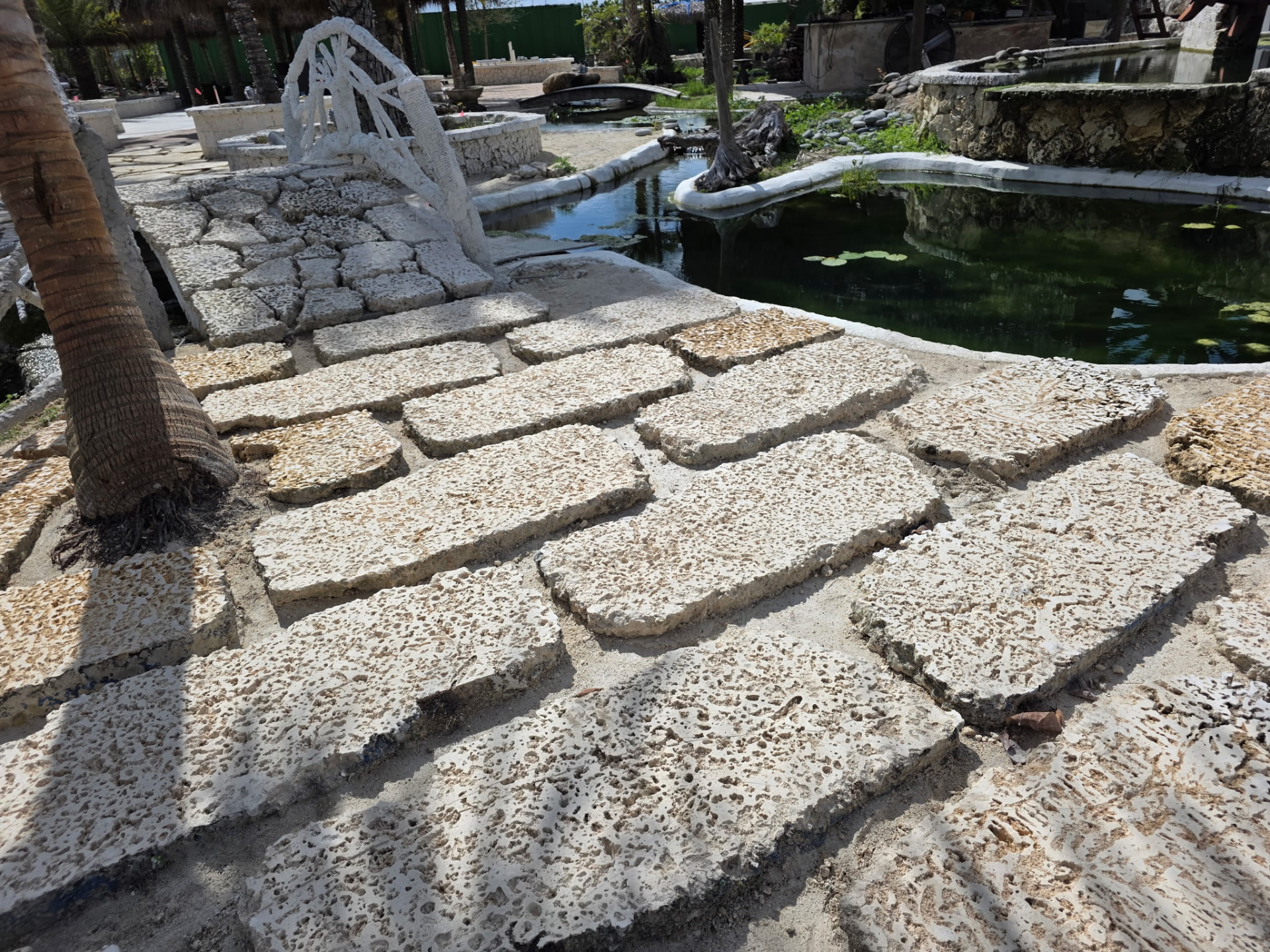 Stone pathway beside a landscaped pond on the event grounds