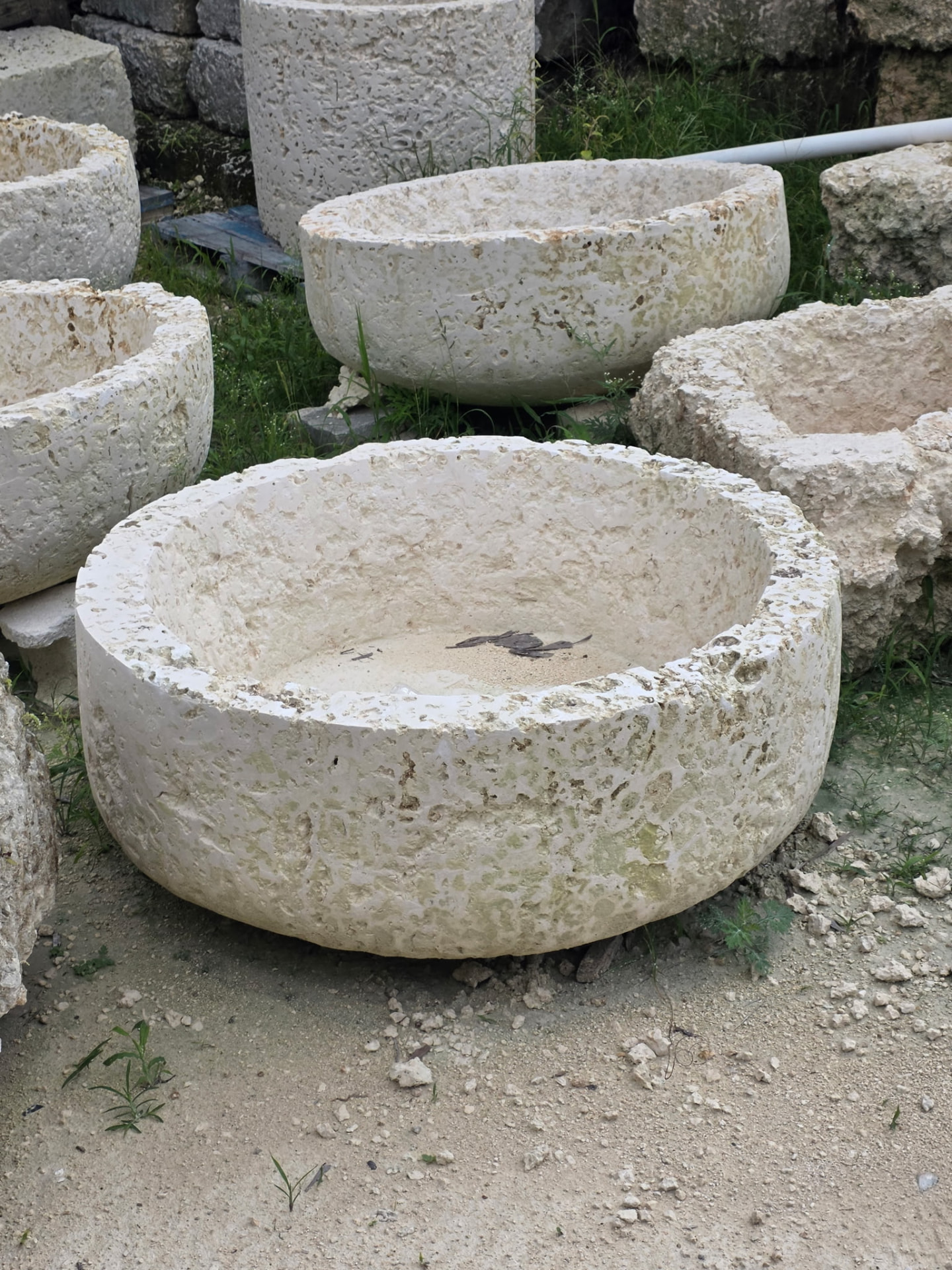 One-of-a-kind stone bowls and vessels in the yard